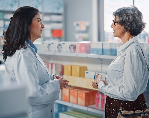 Pharmacist helping customer in store